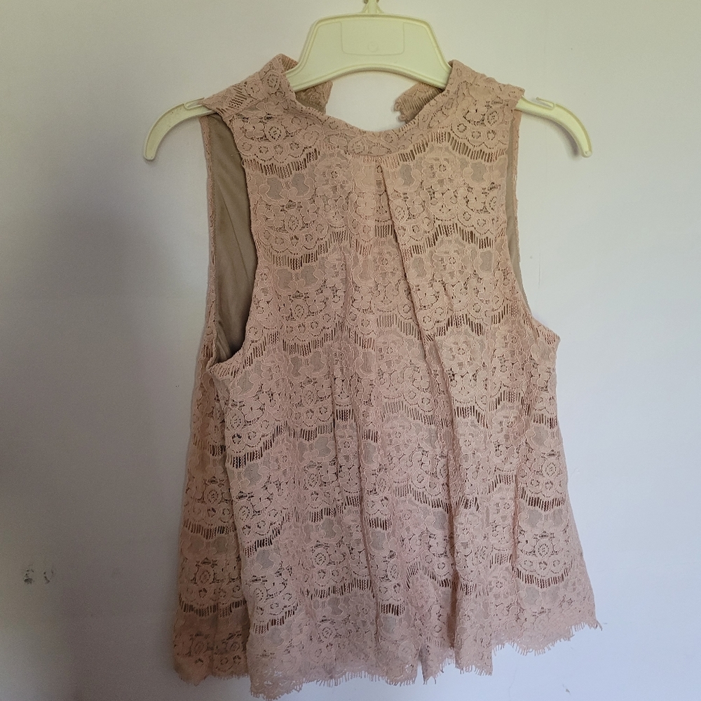 Women's light pink blouse, size M.